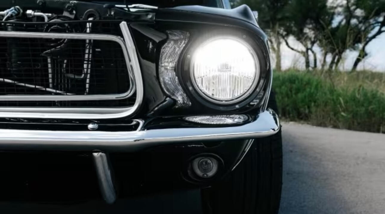 The Mustang parked on an open road